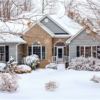 Large house in wooded lot covered in snow