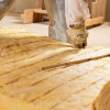 Installing fiberglass insulation in the floors